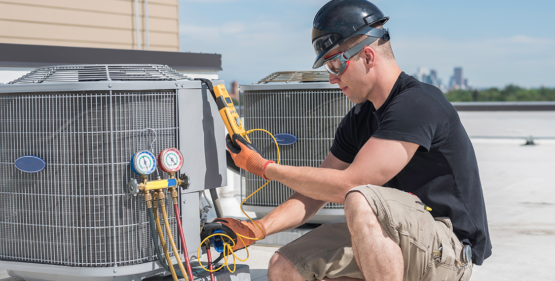 Technician evaluating an AC unit